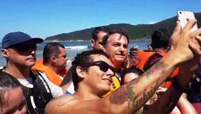 Bolsonaro passeia na praia do Guarujá e posa ao lado de apoiadores