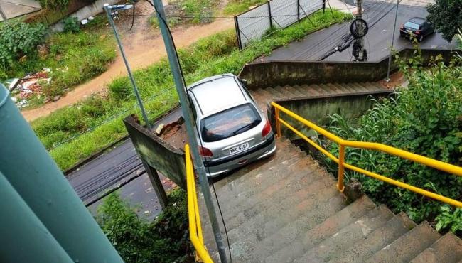 Motorista embriagado desce escadaria com carro e destrói mureta